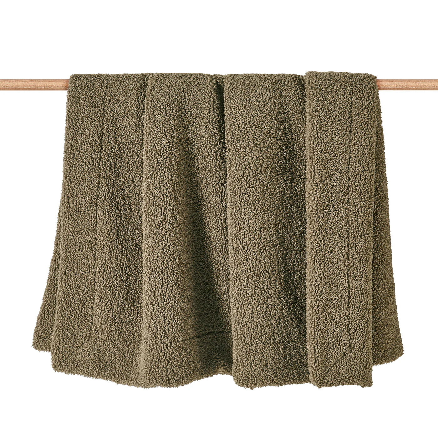 Teddy bear boucle throw blanket in dark oak green with plush curled-loop woven texture, draped over a sofa